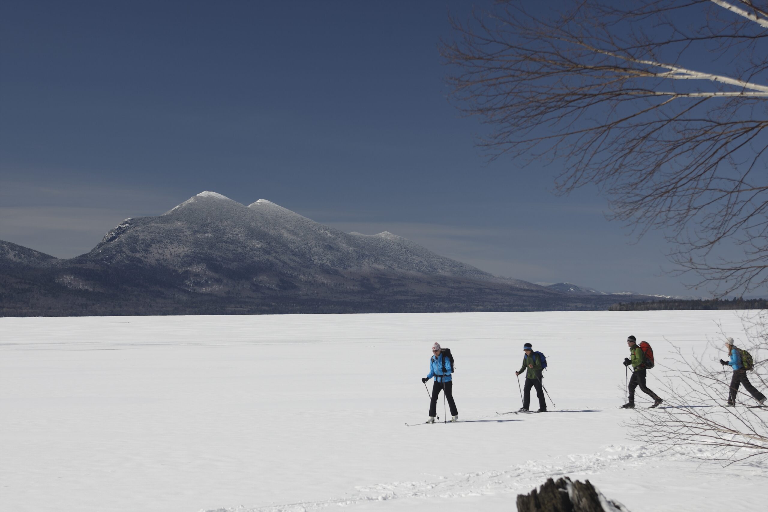 Skiing on Flagstaff Lake with mountains in the background.