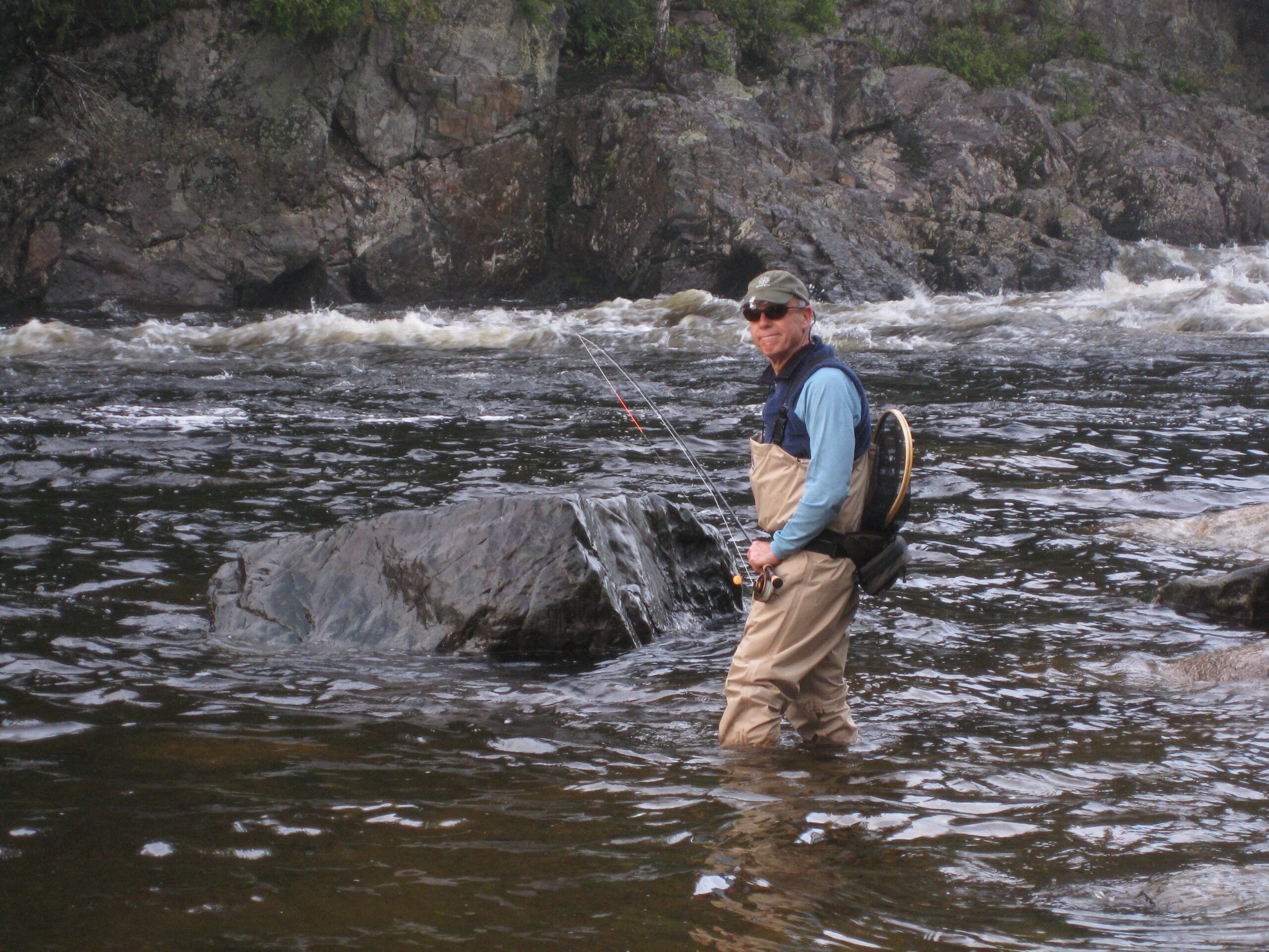 Fly fisherman in the rapids below Grand Falls.