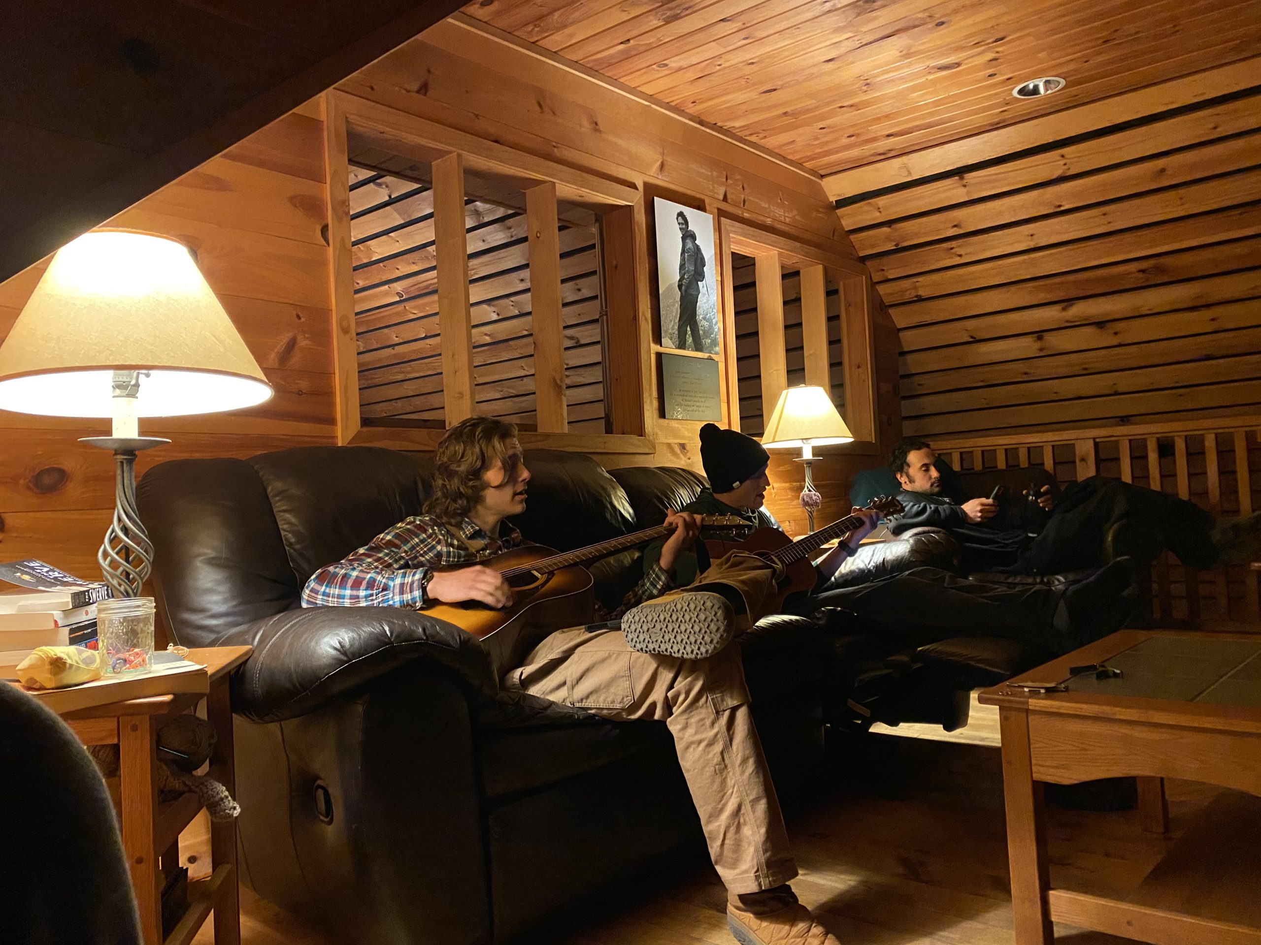 Poplar Stream Hut Lounge with a two people playing guitar.
