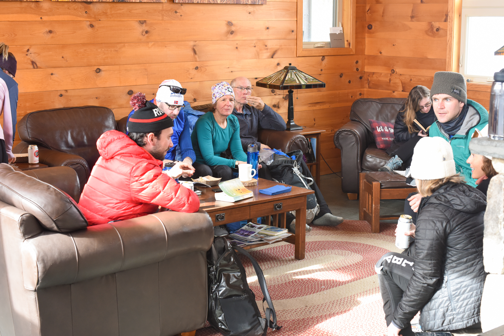 Guests sit in the Stratton Hut lounge during the Alpine Feast.