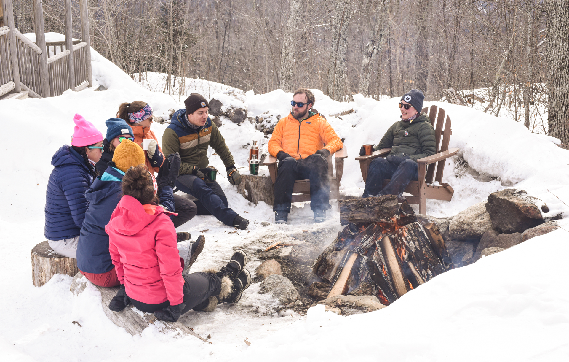 Guests sit around the outdoor firepit at Stratton Brook Hut.