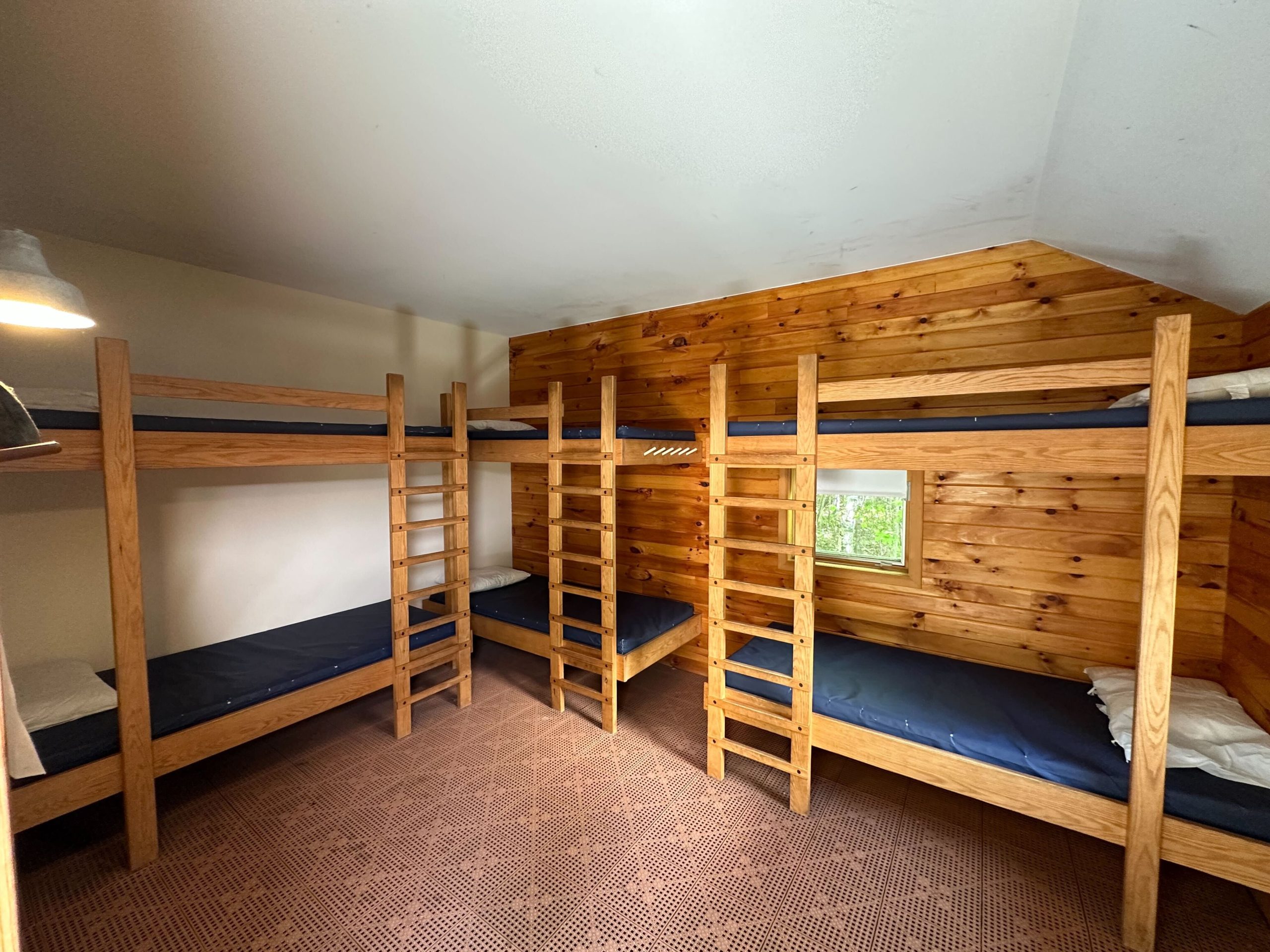 A group bunkroom with 6 bunk beds.