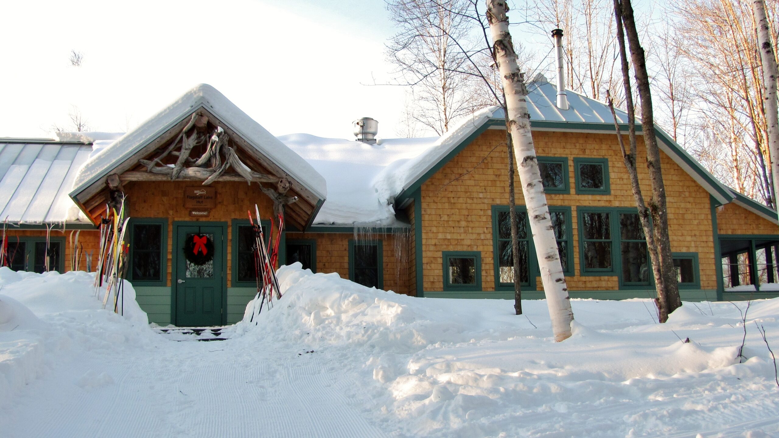 Flagstaff Lake Hut with skis and wreath.