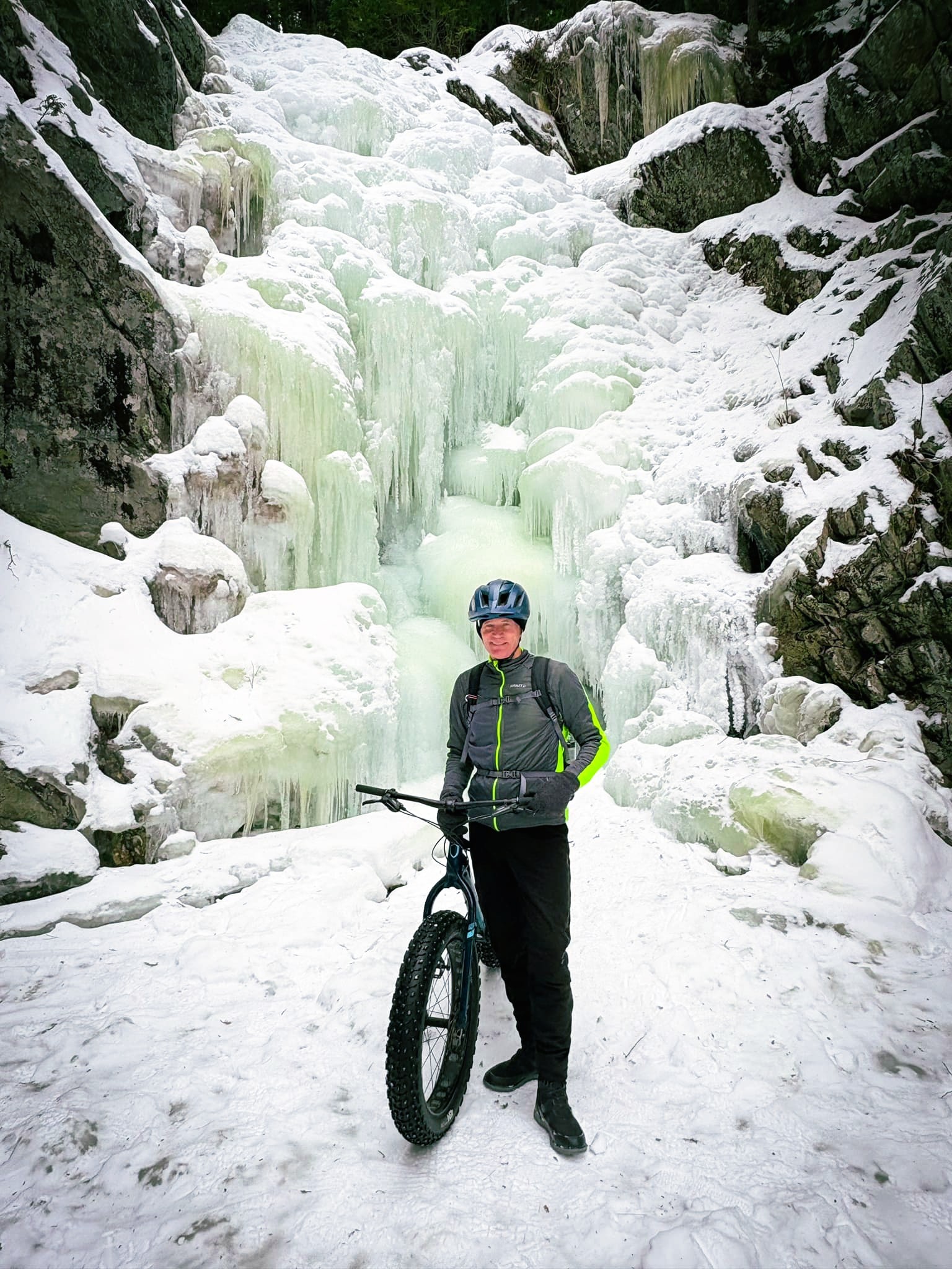 Fat biker at a frozen waterfall near Poplar Stream Hut.