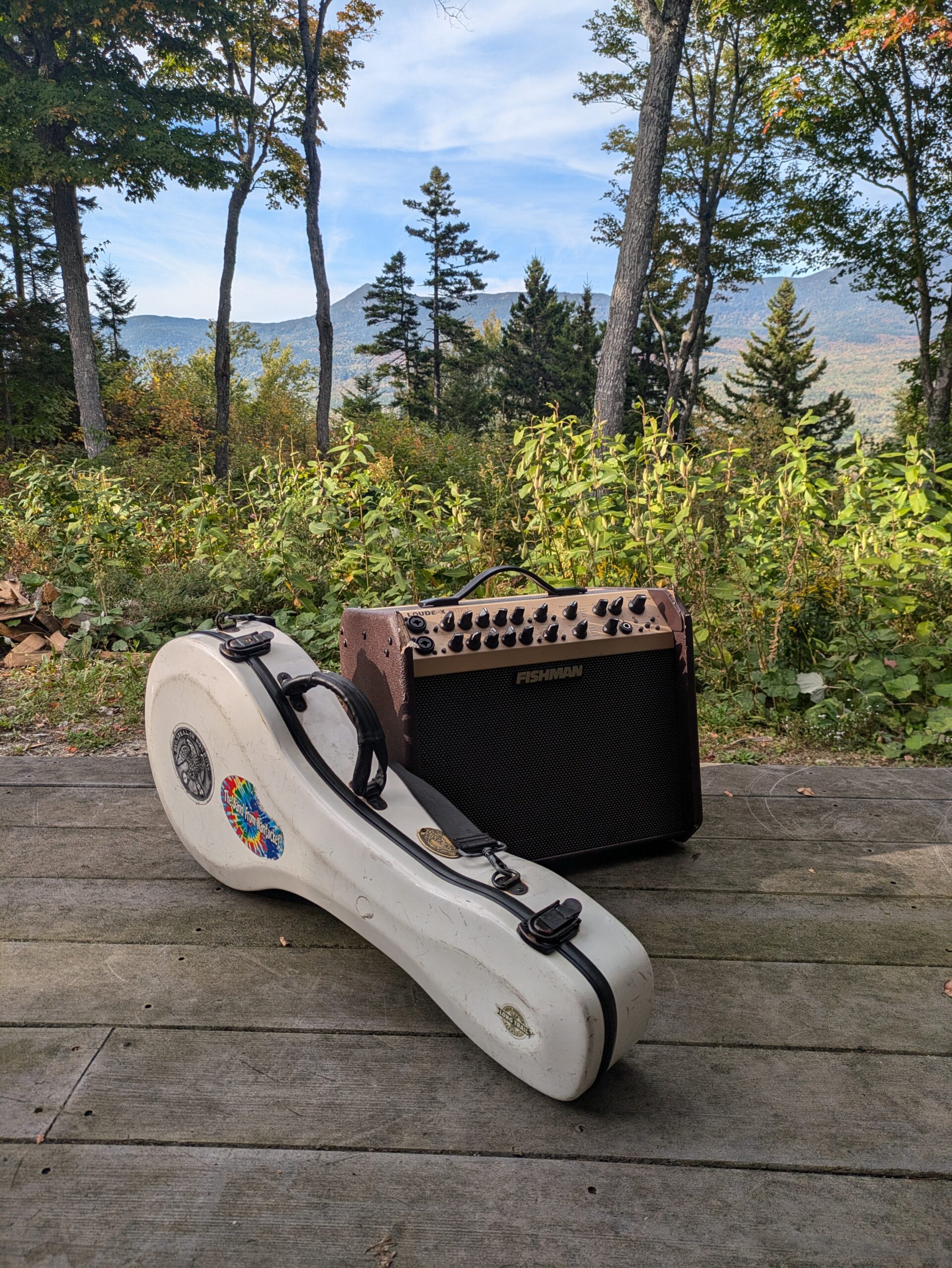 Guitar and amp with the Bigelow Mountains in the background at Stratton Brook Hut.