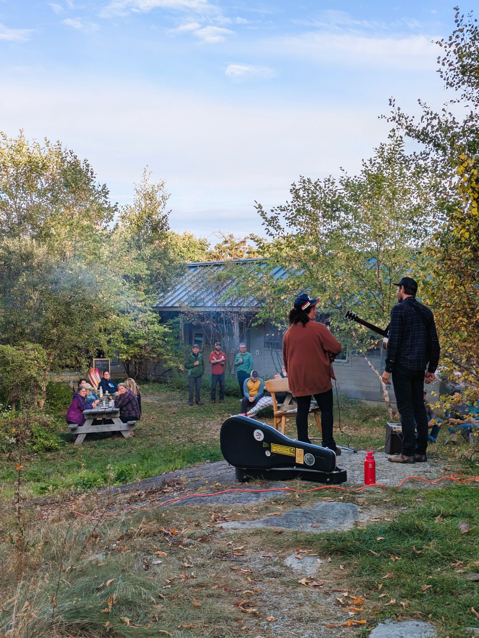 The Geoff Goodhue duo plays outside at Harvest at the Huts