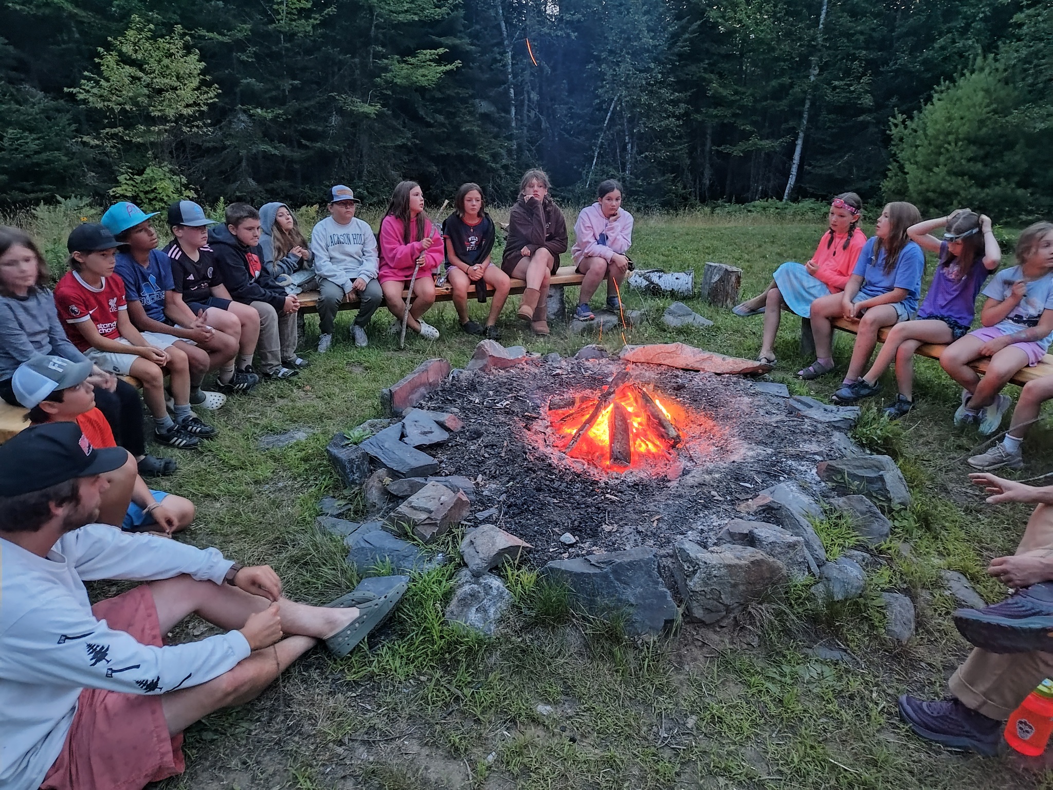 Youth ground around fire pit